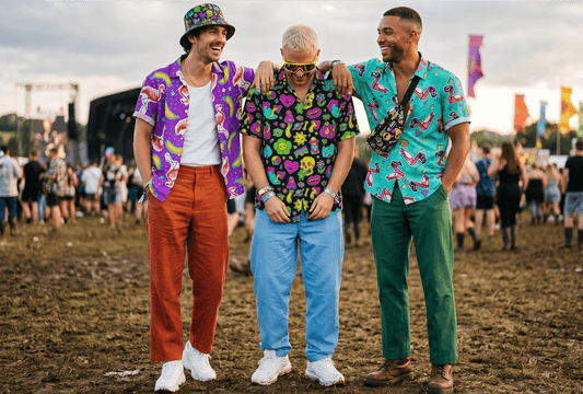 3 men at a festival wearing shit shirts 
