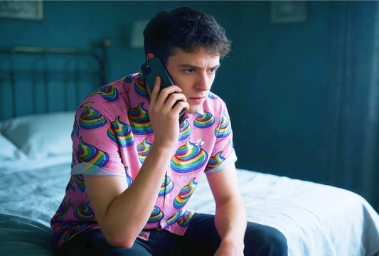Man wearing Unicorn Poo Shirt Looking Sad on the Phone to free mental health support