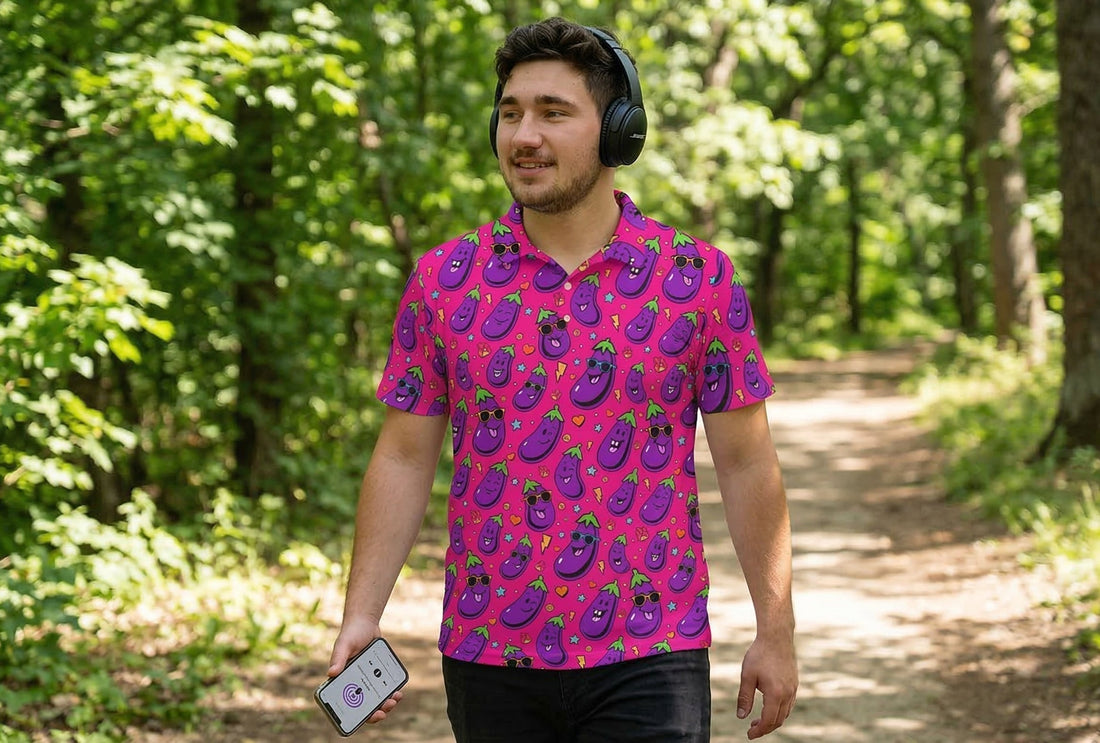 Man walking through the forest listening to a mental health podcast wearing shit shirt club jolly todger polo shirt