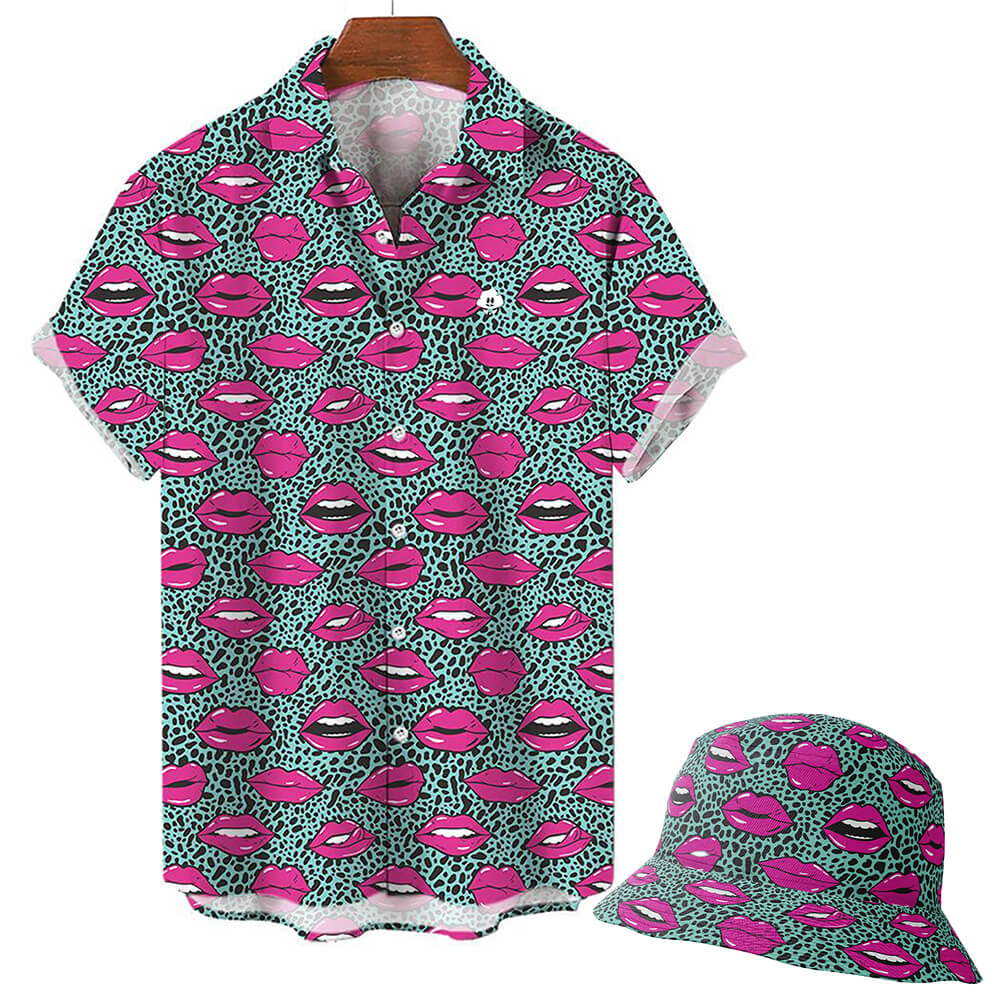 The Leopard Kiss Bad Shirt is a short-sleeve button-up featuring turquoise and black feline patterns with bold pink lips and white teeth illustrations, shown on a white background.