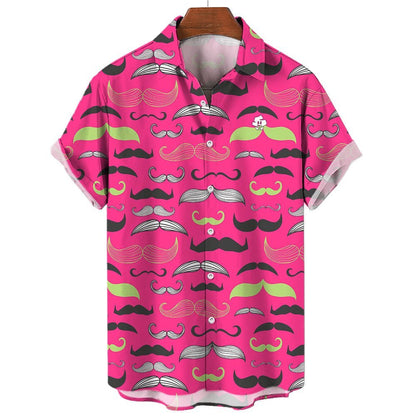 The Movember Shirt is a short-sleeve, button-up with a bright pink background and black, white, and green moustache patterns. A fun cartoon face with a moustache peeks from the pocket—ideal as a statement or Movember shirt.