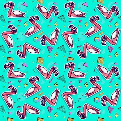 The Flamingo Fandango Shirt features playful pink flamingos, geometric shapes, and squiggles on a teal background in a retro 1980s style—perfect for anyone who loves quirky, fun bird-themed fashion.