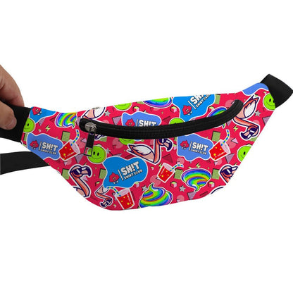 A hand holds a bright pink Badass Bum Bag, decorated with colorful stickers like smiley faces, rainbows, and SH!T SHIT CLUB labels. This playful bag features a black zipper and black straps for easy, hands-free wear.