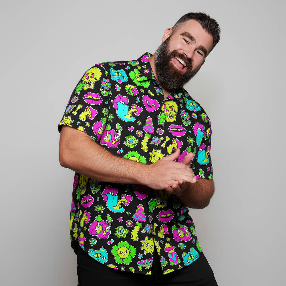 Man wearing a colourful patterned shirt with a gray background