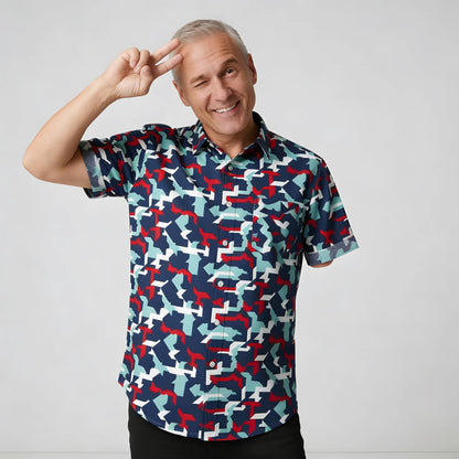 Man wearing a patterned camo shirt with a gray background