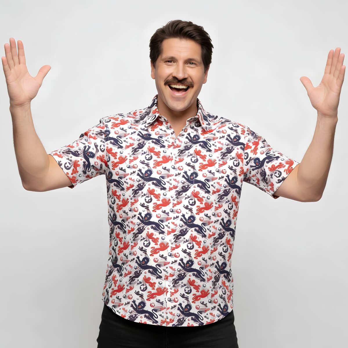Man wearing a colorful patterned England shirt with arms raised on a light gray background