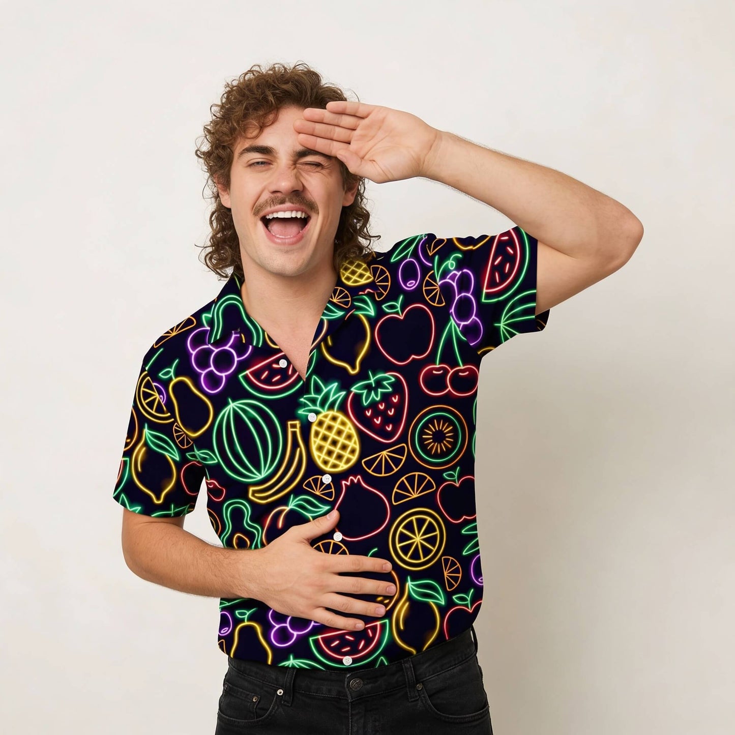 Man wearing a colourful neon fruit pattern shirt on a plain background