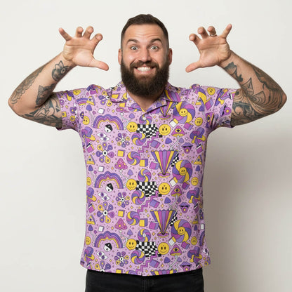 Man wearing a purple patterned shirt with arms outstretched on a plain background