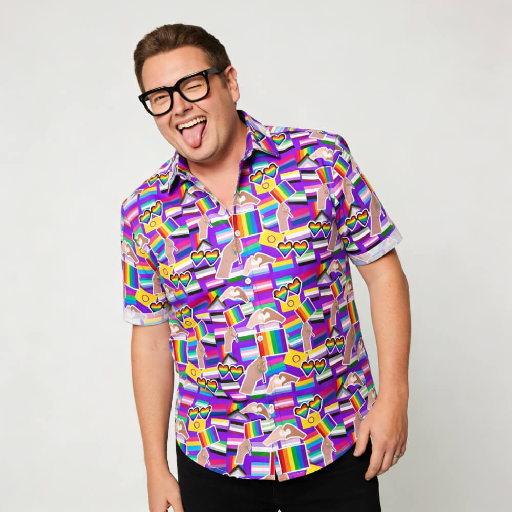 Person wearing a colourful patterned pride shirt with a plain background