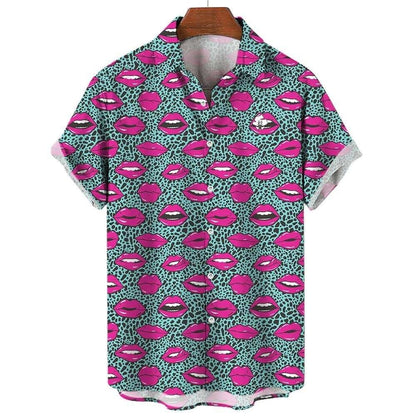The Leopard Kiss Bad Shirt is a short-sleeved button-up featuring bright pink lips and white teeth on a light teal background with small black spots, shown on a wooden hanger—an eye-catching, flirtatious feline pattern.