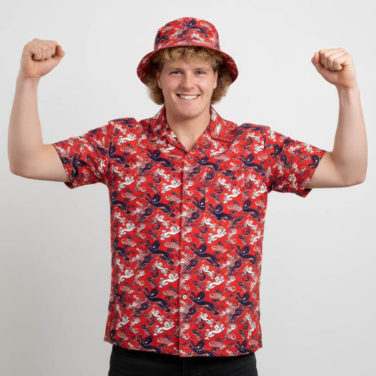 Person wearing a red patterned England shirt and bucket hat on a plain background
