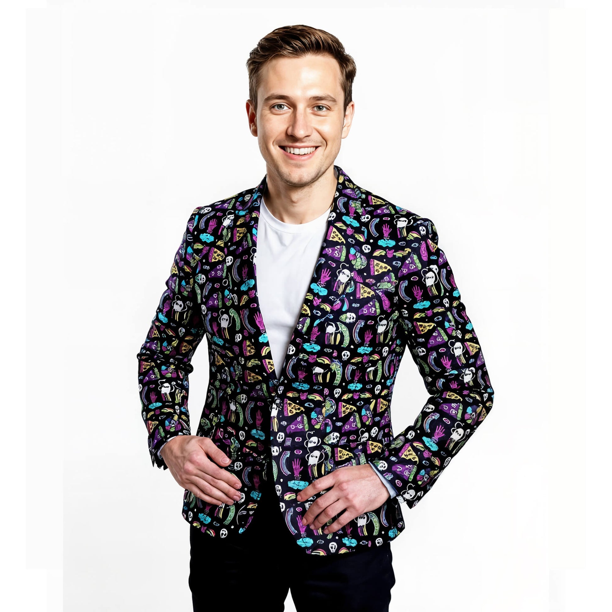 A smiling man poses against a white background, wearing a white T-shirt and the Shroom Blazer—an eye-catching suit jacket featuring playful, cartoon-style graphics in vibrant colors. His hands rest casually near his waist.