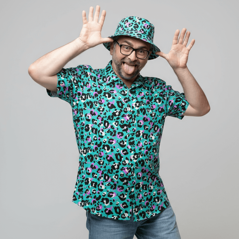 Man wearing the Turquoise Leopard Print Shit Shirt and matching bucket hat on a grey background doing a silly pose 