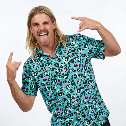Person wearing a turquoise leopard print shirt on a white background