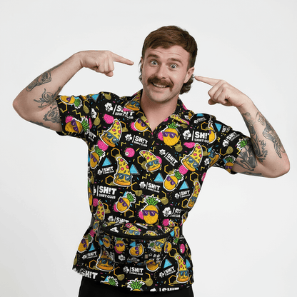 Person wearing a colourful patterned shirt with various designs on a plain background