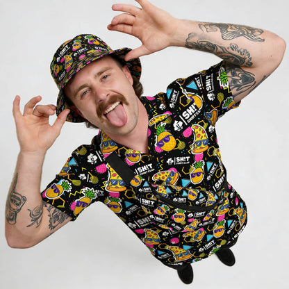 Man wearing a colourful patterned shirt and cap on a white background