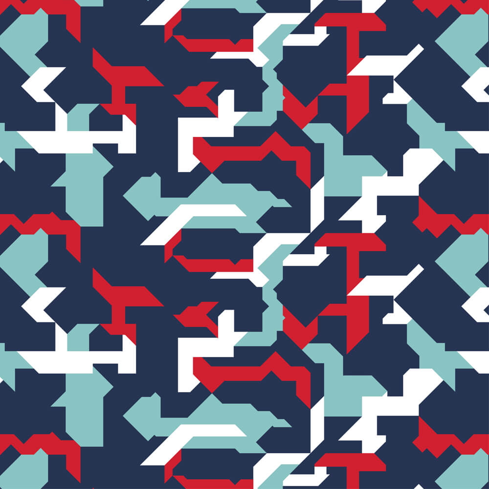 The Combat2Coffee Army Camo Shirt features an abstract geometric pattern with jagged navy blue, white, light blue, and red shapes in a dynamic, angular design inspired by veterans and mental health awareness.