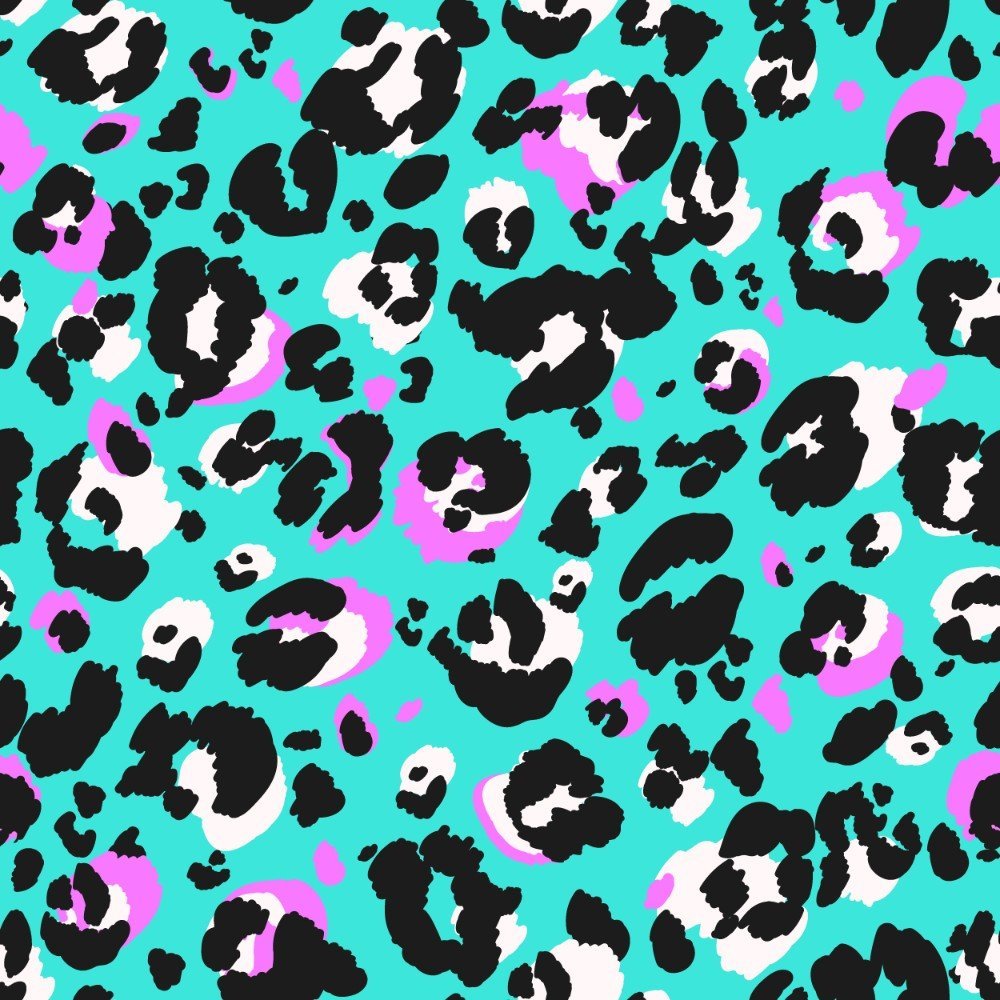 The Turquoise Tempest Leopard Print Shirt features a bold leopard print with black, white, and pink spots on a vibrant turquoise background for a playful, modern take on classic animal print.