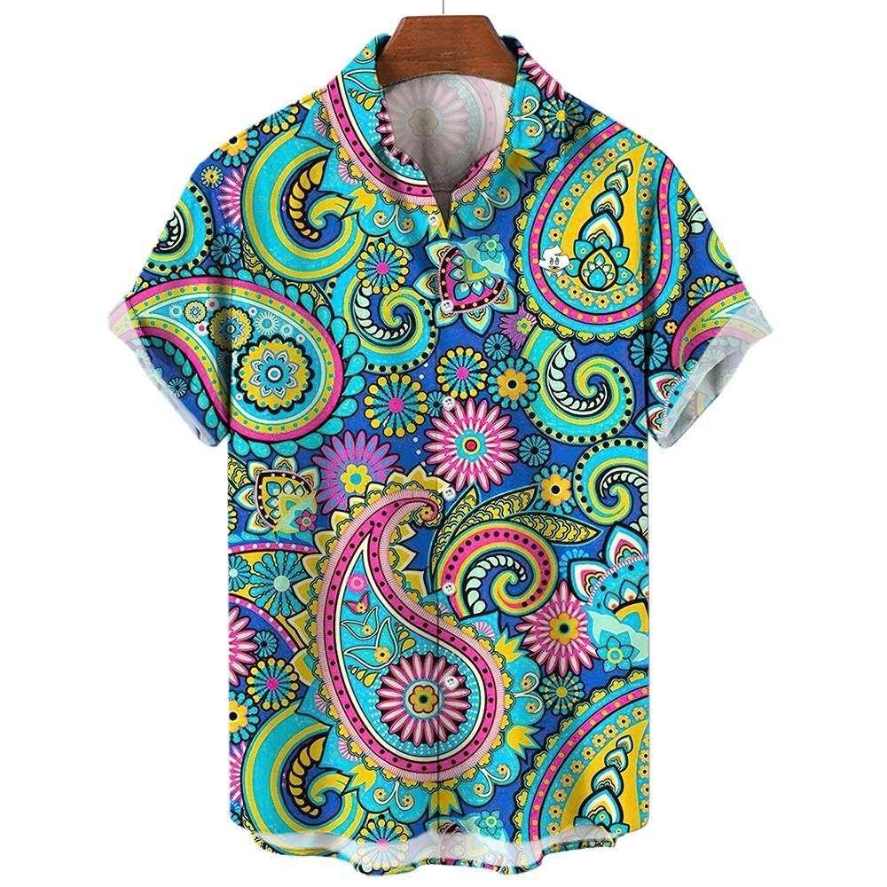 The Psychedelic Explorer Shirt is a short-sleeve button-up featuring a vibrant paisley and floral print in bright blue, yellow, pink, and green, shown on a wooden hanger against a white background.